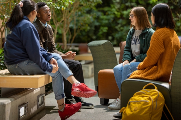 students gathered around table