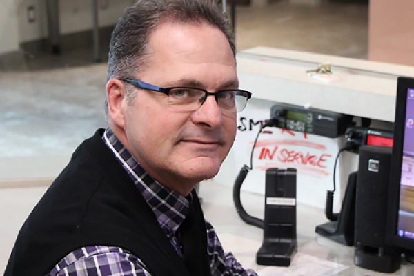 Mike Mackinnon sitting at dispatch desk