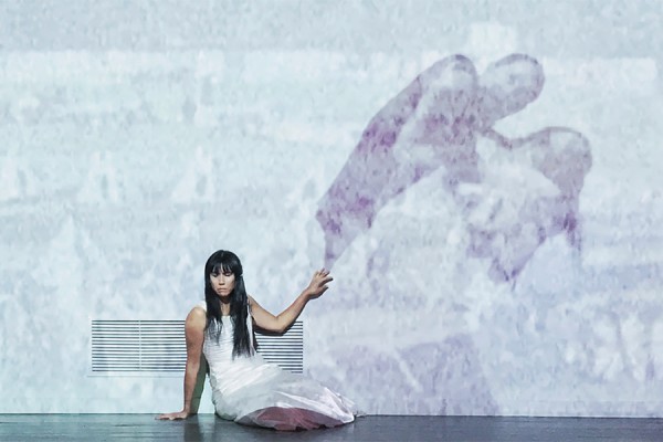 Mariel Belanger performs against projection