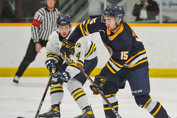 Winger Keegan McMullen checks an opponent