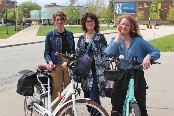 Nicole Noel, Natasha Wiebe, and Kate Rosser-Davies with bicycles