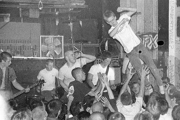 man stage diving at concert