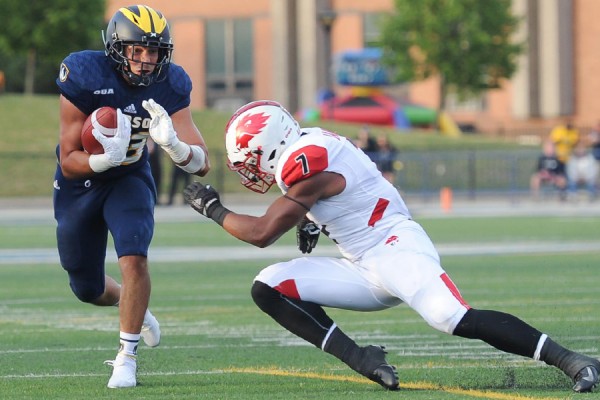 Running back Jacob Savoni evades a tackler