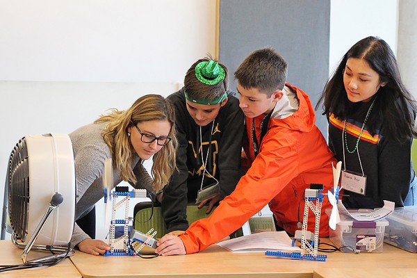 Participants in Take Our Kids to Work Day test the model wind turbine they built as an activity organized by the Faculty of Engineering.