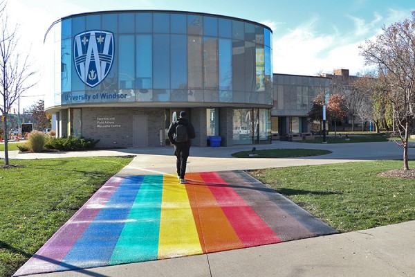 Sidewalk painted in rainbow leading to Welcome Centre