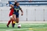 soccer player Aislynn Essibrah evades a defender