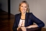 Anita Nowak with crossed arms and empathetic smile.