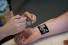 person sprinkling glitter on temporary tattoo that reads "Hope"
