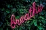 neon sign reading "Breathe"