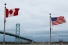 Canada and U.S. flags flank the Ambassador Bridge