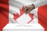 hand depositing ballot in box before Canada flag