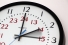 Clock showing hour hand turning back from 3 to 2
