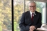 UWindsor president Robert Gordon posed casually and smiling in suit