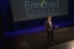 man on stage with banner "Enriched Academy"