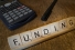 Scrabble tiles spelling "Funding"