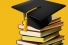 mortarboard balanced on pile of books