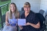 UWindsor alumnae Anne-Marie DePape and Christine Quaglia hold children's book.