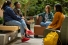 students sitting in group conversing happily