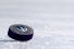 Hockey puck bearing Lancer logo.