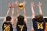 men's volleyball players blocking shot at net