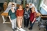 Four women stand at foot of hospital pateint's bed: Dana Ménard, Laurie Freeman, Kendall Soucie, and Jody Ralph