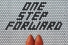 floor tiles spelling out "One Step Forward"