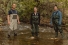 Trevor Pitcher, student Bri Curtis, and Catherine Febria stand in a stream