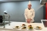 chef displaying dishes of food in kitchen