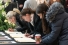 women signing book of condolence