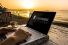 laptop on beach displaying text "Continuing Education"