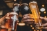 hands raising celebratory glasses
