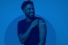 young man rolling up sleeve to show site of his vaccination