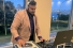 R.J. Sivanesan wearing headphones behind deejay turntables