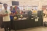 Students standing beside tradeshow booth featuring sustainability.