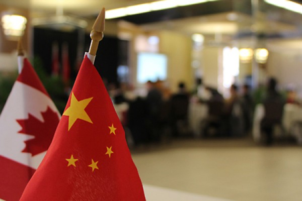 Canadian and Chinese flags adorn conference hall