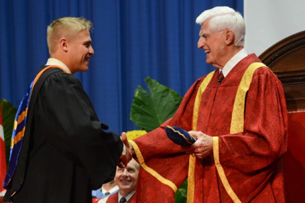 Chancellor Edward Lumley (right) congratulates a new member of the UWindsor alumni family Saturday during the University’s 100th Convocation.