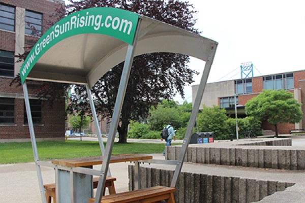 Green scene: The solar bench—which uses the sun’s rays to charge electronics—frames a recycling station, a bicycle rack and the Stewart Moore Carolinian Garden to point up the University of Windsor’s commitment to environmental responsibility.
