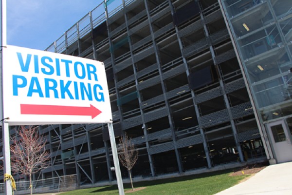 &quot;Visitor Parking&quot; sign in front of garage