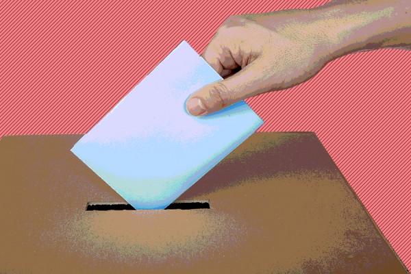 hand placing ballot in box