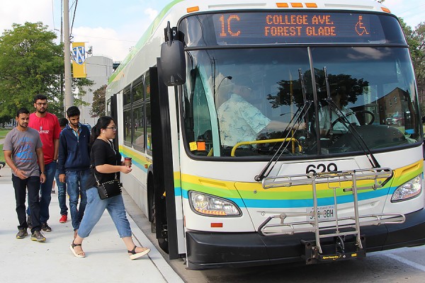 Passengers boarding bus at north end of main campus