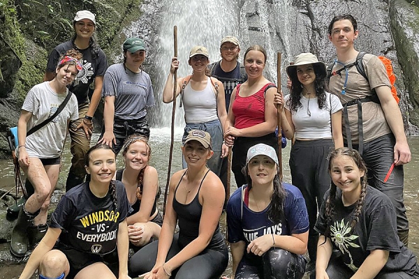 group of students in front of waterfall in Costa Rica