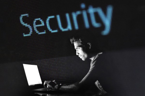 Person working at computer in darkened room