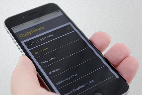 hand holding smart phone displaying DailyNews