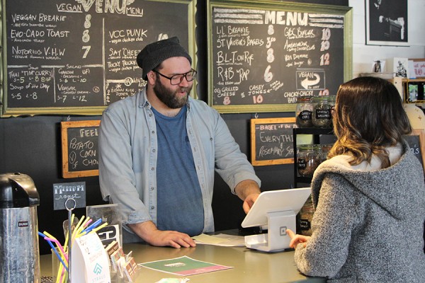 Green Bean waitstaff with customer