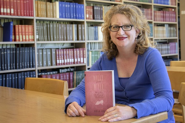 Heidi Jacobs holds copy of Molly of the Mall.