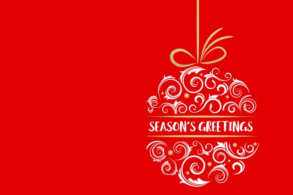 red holiday card with season&#039;s greeting written inside tree ornament