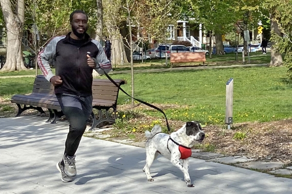 Jaydee Tarpeh jogging with dog on leash