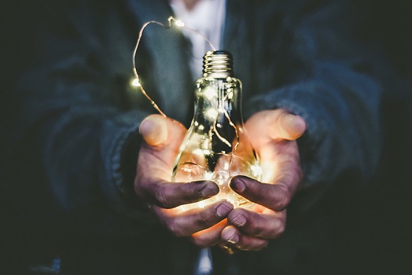 hands holding lightbulb