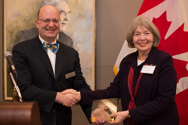 Chi Carmody, Canadian director of the Canada-United States Law Institute, presents the Sidney Picker Jr. Award to law professor emerita Maureen Irish.