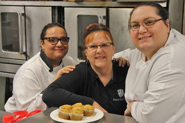 Food Services staff pose with muffins